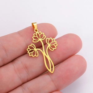 Detailed view of a gold hollow three-lotus flower pendant held to show scale and metal texture