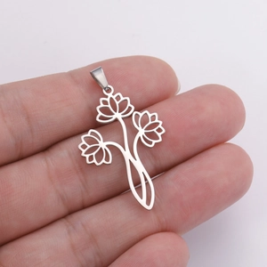 Hand holding a matte silver stainless steel hollow triple lotus flower pendant charm