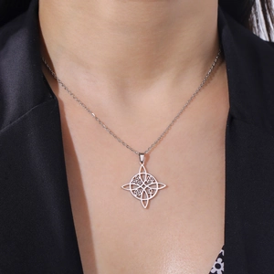 Witch knot stainless steel necklace featuring Celtic symbols and pentagram on black blazer