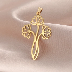 Detailed view of a gold hollow three-lotus flower pendant on champagne satin fabric