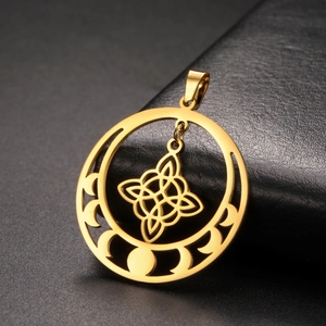Detailed view of golden witch knot pendant with moon phase cutouts and polished finish