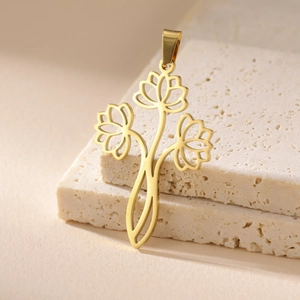 Close-up of golden hollow triple lotus flower pendant on textured stone background