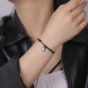 Bohemian handmade knotted cord bracelet with silver soccer ball pendant on wrist