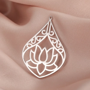 Macro detail of teardrop-shaped lotus flower pendant in polished stainless steel