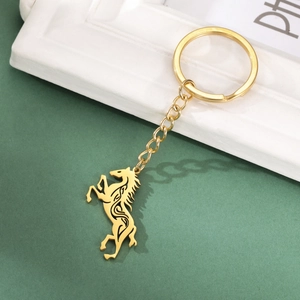 Golden Celtic horse keychain with tribal patterns in a dynamic galloping pose pendant