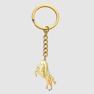 Detailed close-up of a golden hollow-out Celtic horse pendant on a polished keychain