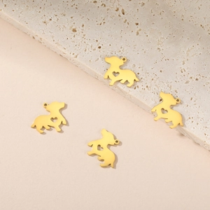 Detailed view of four golden stainless steel dachshund dog charms with heart cutouts