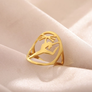 Macro shot of gold hollow rhythmic gymnast ring on premium champagne silk fabric