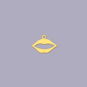Macro detail of 18K gold plated stainless steel lip pendant on a purple background
