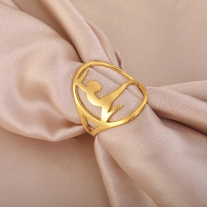 Golden gymnast hollow ring made of stainless steel displayed on elegant silk background