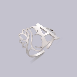 Detail of silver hollow ring featuring artistic letter A and female profile silhouette