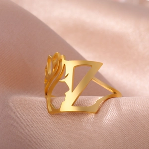 Macro shot of gold stainless steel hollow ring featuring artistic profile and letter Z
