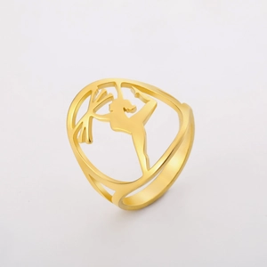 Macro detail of gold stainless steel ring with hollow rhythmic gymnastics dancer silhouette