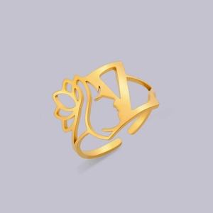 Detailed close-up of hollowed-out female face and lotus flower on a gold-plated ring