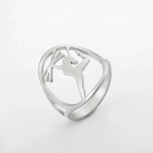 Detailed view of polished stainless steel ring with laser-cut female gymnast silhouette