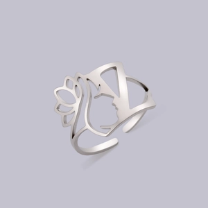 Detail of cutout portrait design and floral pattern on a silver adjustable ring