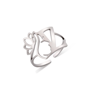 Detail showing cutout female profile silhouette and floral pattern on silver open ring