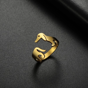 Golden stainless steel dachshund silhouette open ring on dark grey leather background