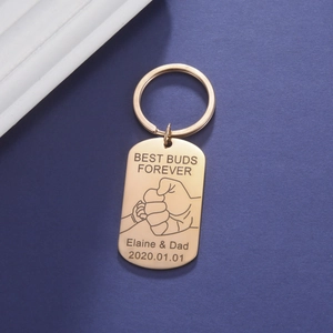 Detailed engraving on gold titanium steel keychain with fist bump and custom date