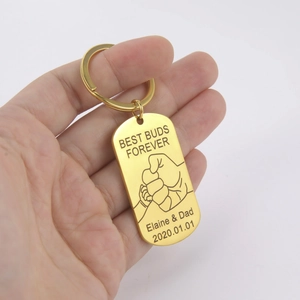 Close-up of golden customized Best Buds Forever rectangular keychain with fist bump engraving
