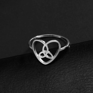 Polished silver stainless steel Celtic knot heart ring on a black leather background