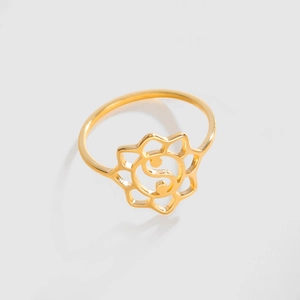 Detailed view of hollow lotus and yin yang symbol on gold stainless steel ring
