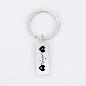 Detail view of silver stainless steel keychain with custom heart and heartbeat engraving