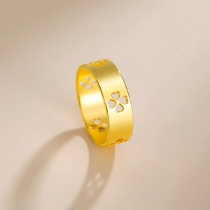 Detailed view of golden stainless steel ring featuring cutout clover heart patterns
