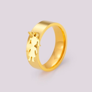 Close-up of a gold stainless steel ring featuring a delicate hanging girl-shaped charm