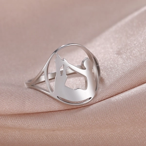 Detailed view of cutout silver ring showing a mother holding a baby on pink satin