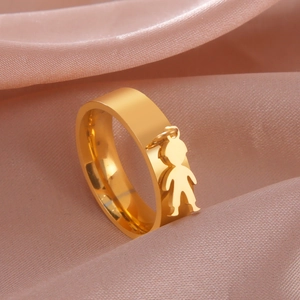 Detailed side view of a gold stainless steel ring featuring a small boy charm pendant