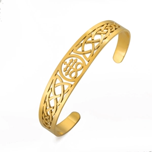 Golden cutout cuff bracelet featuring Leviathan Cross and Celtic knot patterns