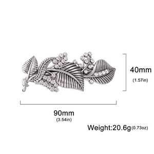 Vintage silver leaf hair clip with rhinestones and dimensions shown on white background
