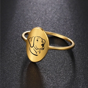 Macro detail of 18K gold plated oval ring featuring laser engraved dog head silhouette