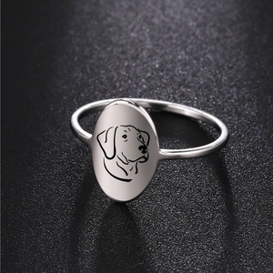 Polished stainless steel ring featuring minimalist laser-etched dog portrait on oval face
