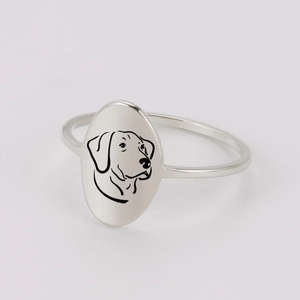 Detail of minimalist stainless steel ring with laser engraved dog silhouette