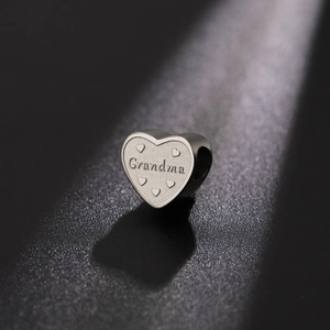 Polished heart-shaped grandma pendant with 18K gold finish and decorative engraving