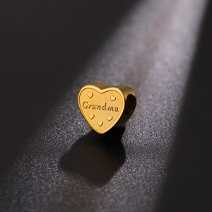 Gold heart pendant with Grandma engraving and tiny embossed hearts for DIY jewelry