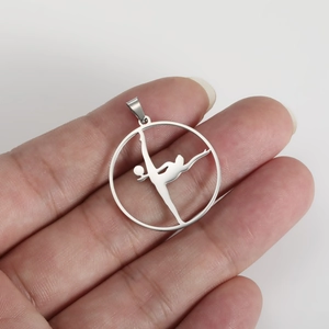 Polished stainless steel gymnastic girl pendant held by hand for jewelry DIY