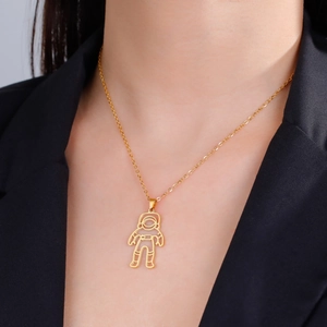 Gold astronaut hollow pendant necklace with polished finish shown on a model