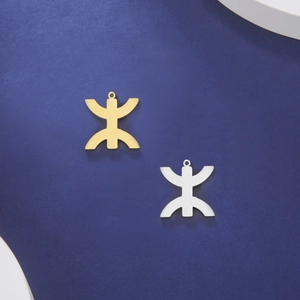 18K gold and silver plated Amazigh symbol pendants on a blue textured background
