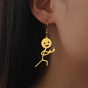 Funny gold stickman earrings with middle finger gesture shown on a female model