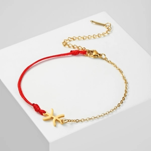 Detail of red cord and 18K gold-plated chain bracelet with Pisces pendant and lobster clasp
