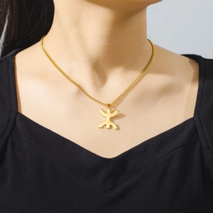 Close-up of 18K gold plated stainless steel Berber Yaz symbol pendant on a model
