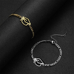 Pair of gold and silver graduation cap pendant bracelets on a black textured background