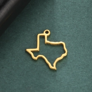 Golden hollow Texas state map pendant in stainless steel on dark green background