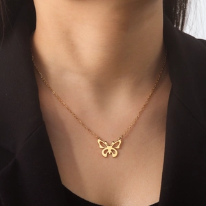 Elegant gold stainless steel hollow butterfly pendant necklace worn with a black blazer