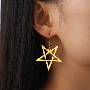 Golden irregular star-shaped dangling hook earrings on model with polished finish