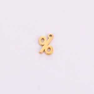 Macro detail of a golden percentage symbol charm made of titanium steel for DIY jewelry making