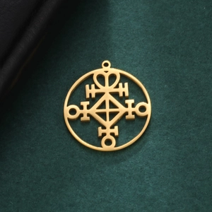 Golden titanium steel circular pendant with hollow geometric rune symbols on green texture